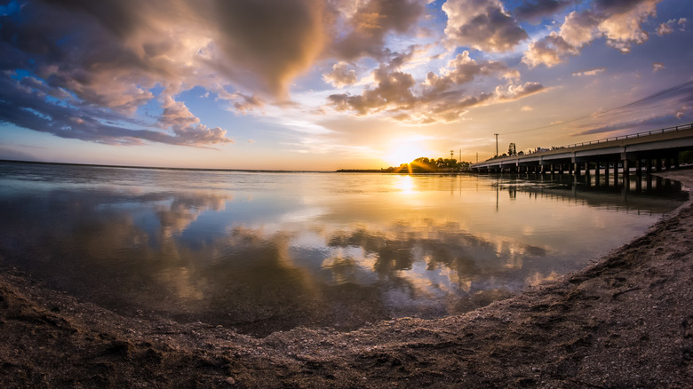 Sunset over Blind Pass Beach at Sanibel-Captiva border with pier visible on right