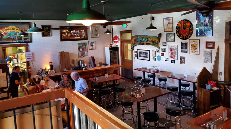 Tables and eclectic decor inside of O'Zone Pizza Pub in Pensacola, Florida