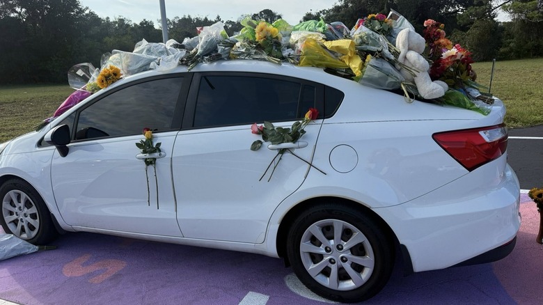 Anna Kepner's white car decorated with flowers and memorials
