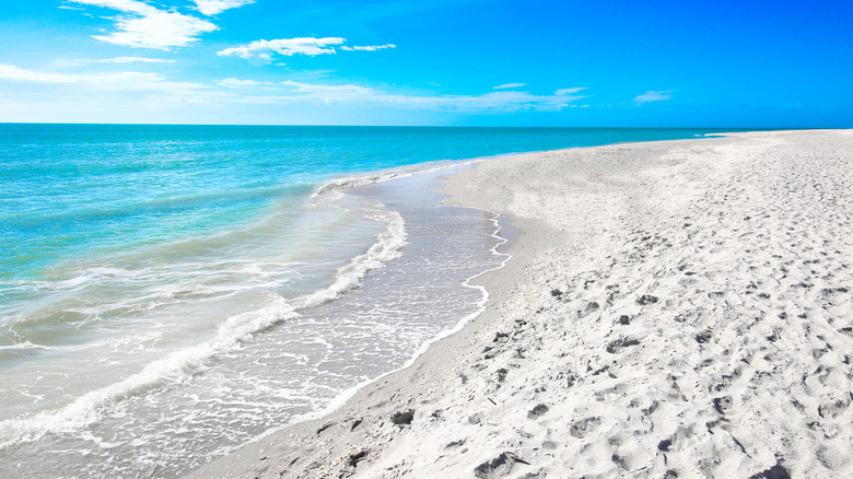 White sand blue sea blue sky with clouds Sanibel Florida