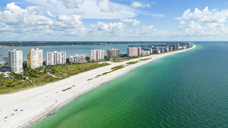 Sand Key white beach emerald water with buildings in Clearwater Florida