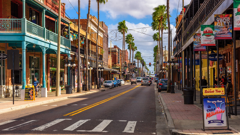 A palm tree lined street and old style buildings