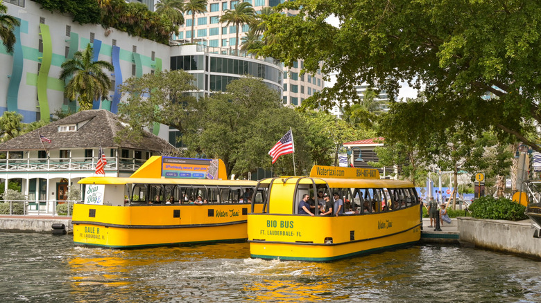 Two yellow Fort Lauderdale Water Taxis picking up passengers.