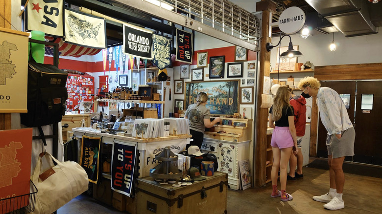 Framed prints, wall tapestries, and grooming products on display at Freehand Goods.