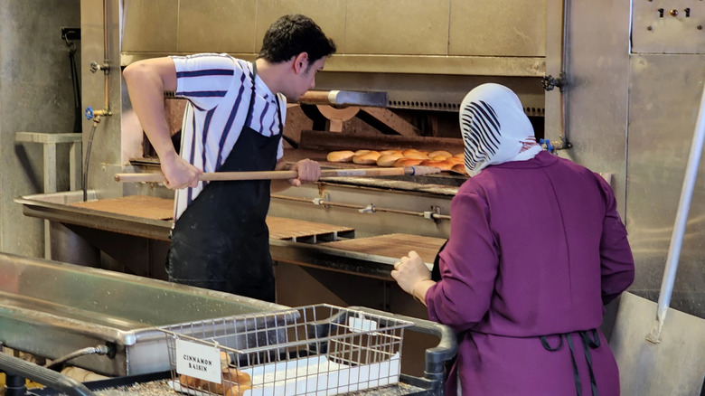 The staff by a bagel oven at a shop in Tampa
