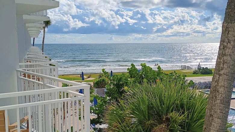 View of the ocean and beach from guest room balcony at Best Western Aku Tiki Inn in Daytona, Florida