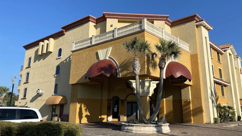 Exterior view of Old World-inspired Castillo Real hotel near St. Augustine on a cloudless day