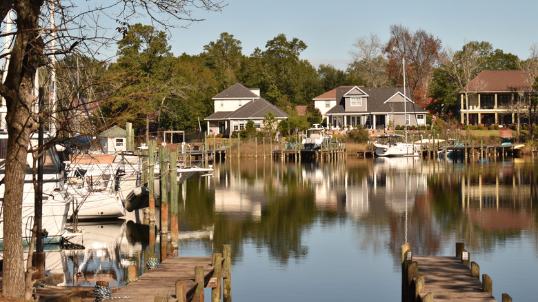 Wooden walkways lead to bay lined with homes and boats