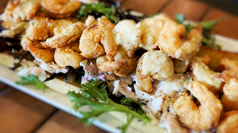 close-up of plate with fried shrimp and leafy greens