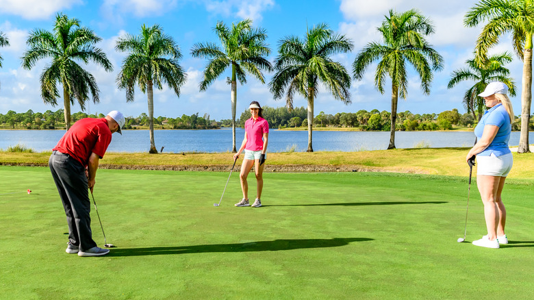 Three people golfing on a Florida golf course