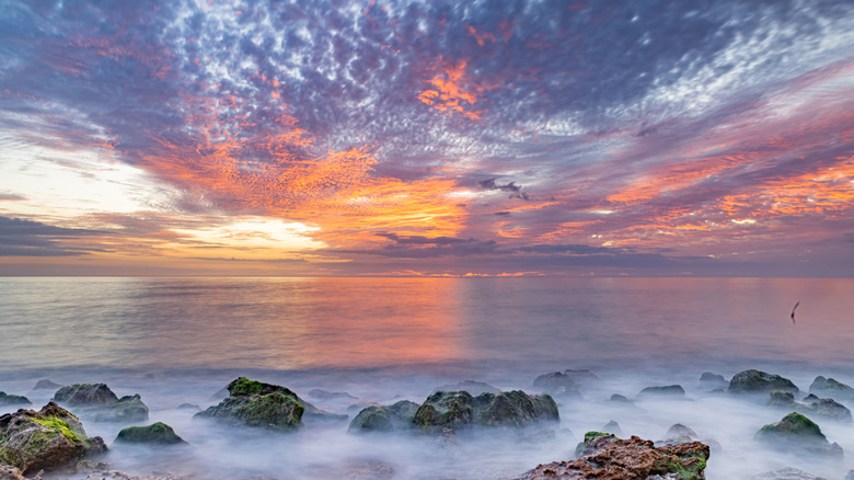 Sunset over the rocky shore of Caspersen Beach