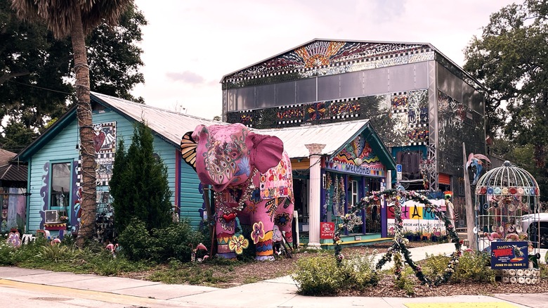 Pink elephant sculpture against decorated building