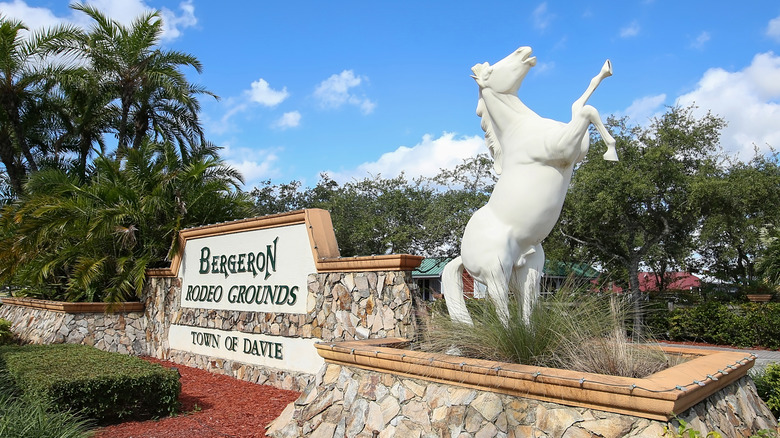 Bucking bronco statue and sign at the entrance to the Bergeron Rodeo Grounds in Davie