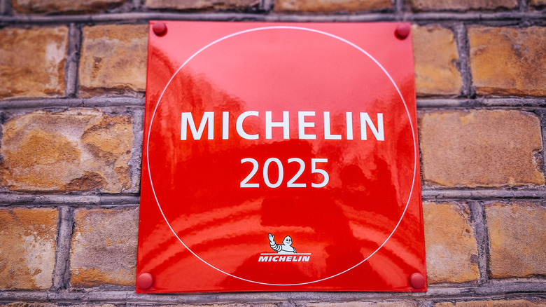 A Michelin 2025 sign hung on a brick wall