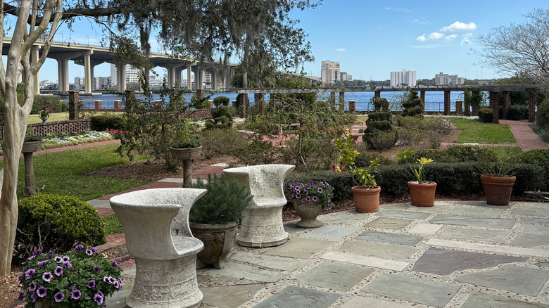 A garden area with bridge and city in background
