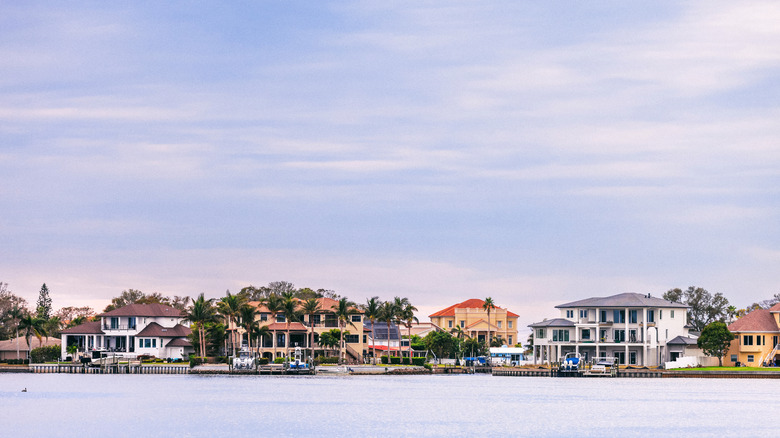 A view from the water of mansions with boat ramps at Palm Harbor