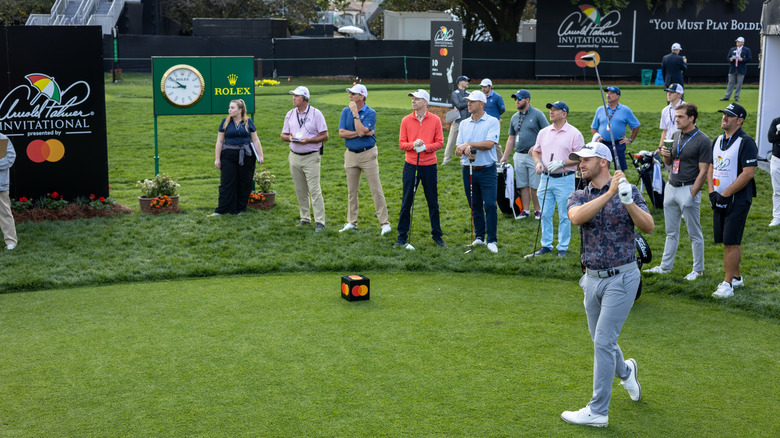 Onlookers watching as man taking a swing at Bay Hill golf course at Arnold Palmer Invitational
