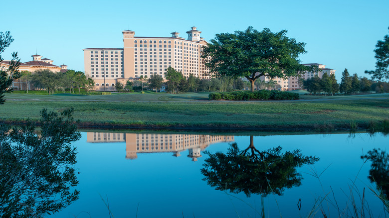 Golf course by lake with hotel in background at Shingle Creek in Orlando