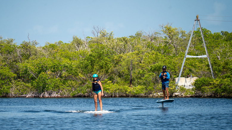 Two people on e-foils at The Lagoon on Grassy Key in Marathon, Florida