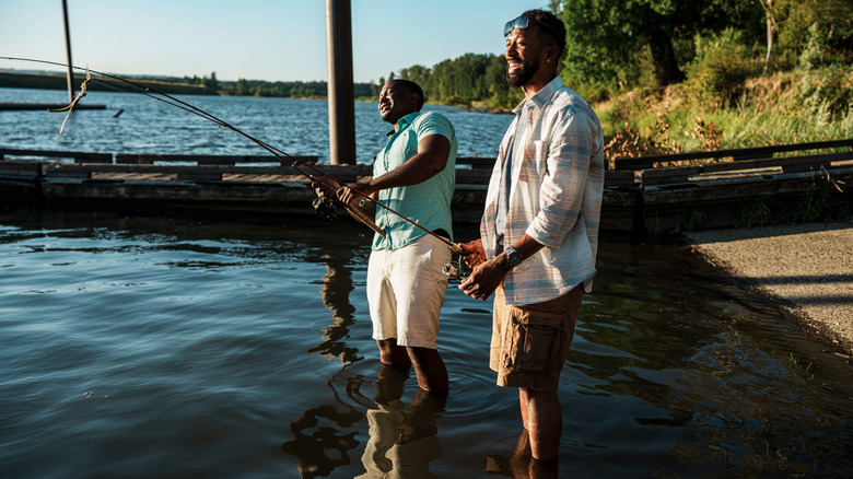 Two men fishing on the shores of a lake