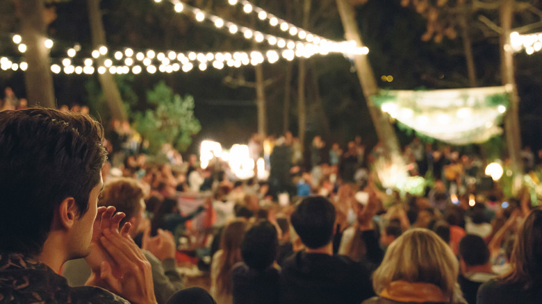 Crowd enjoying outdoor festival at night