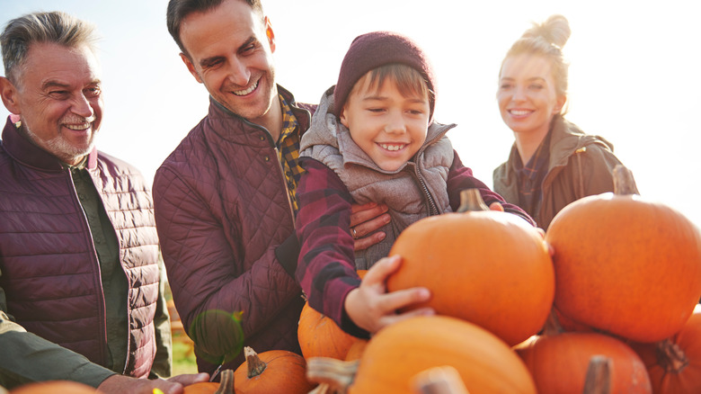 Smiling family at a pumpkin patch