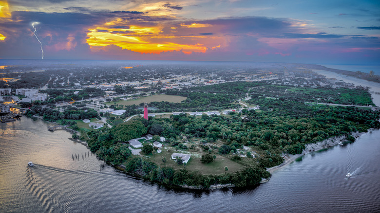 Aerial view of Tequesta, Florida with a sunset and lightning strike in the background.