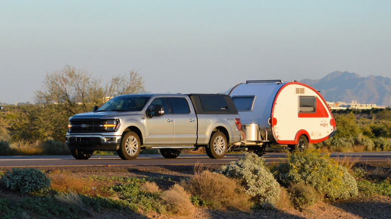 Car towing a teardrop camper