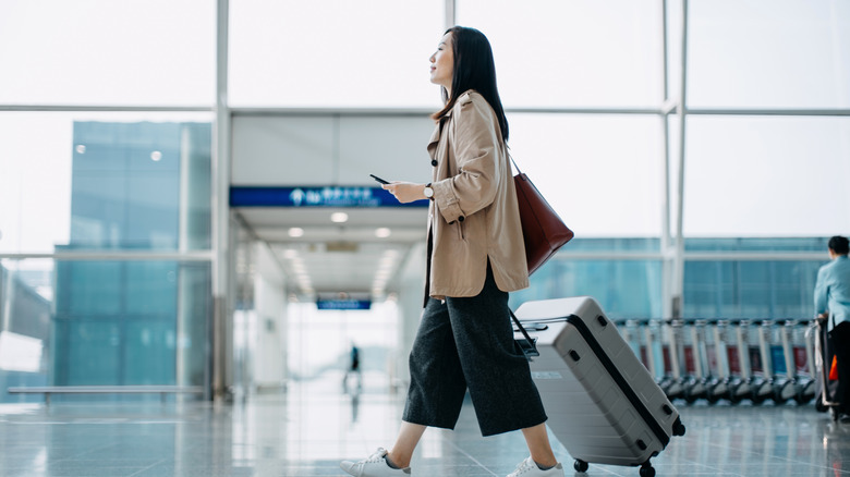 Woman walking through an airport