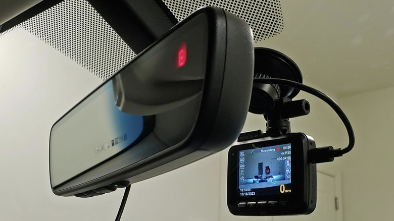 Dash cam mounted on a windshield near mirror