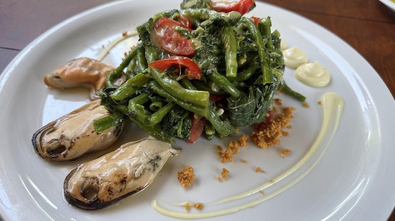 a plate of mussels and greens