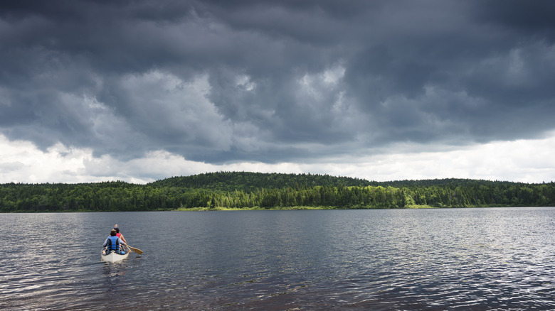 Two people canoeing in a lake at La Mauricie National Park, Canada