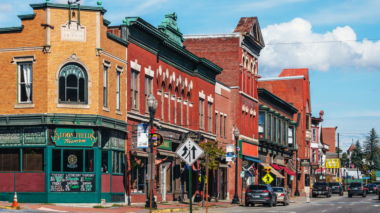 Brick facades line a street on a sunny day in downtown Skowhegan, Maine