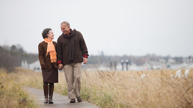 Couple walking along boardwalk near the water