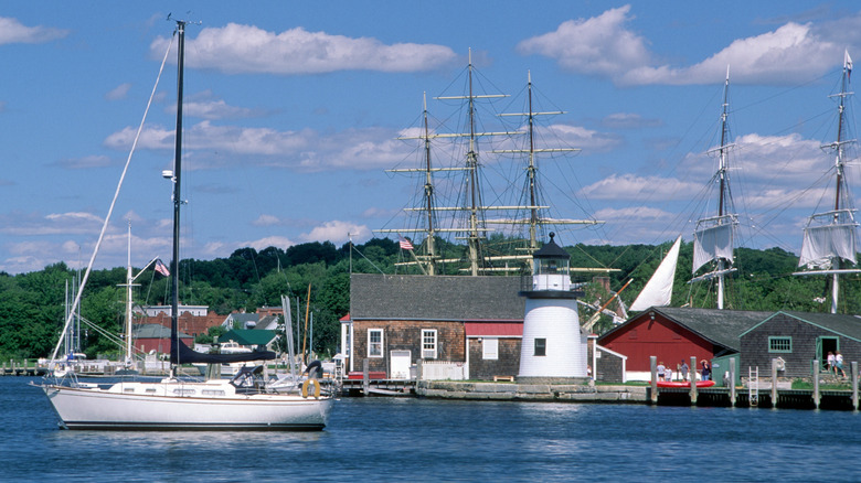 Lighthouse and boats on the water in Mystic