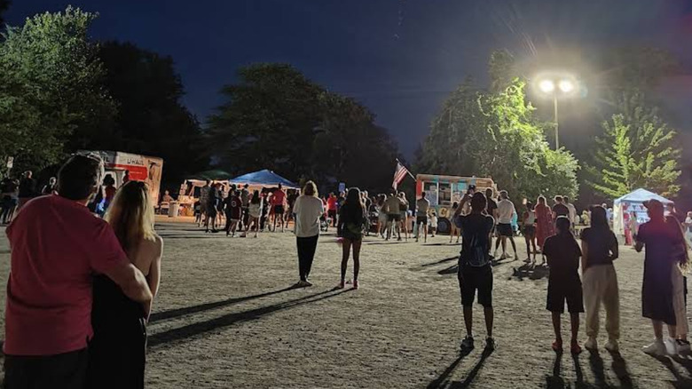 People enjoying a night out at a community event at a park in Sharon, MA
