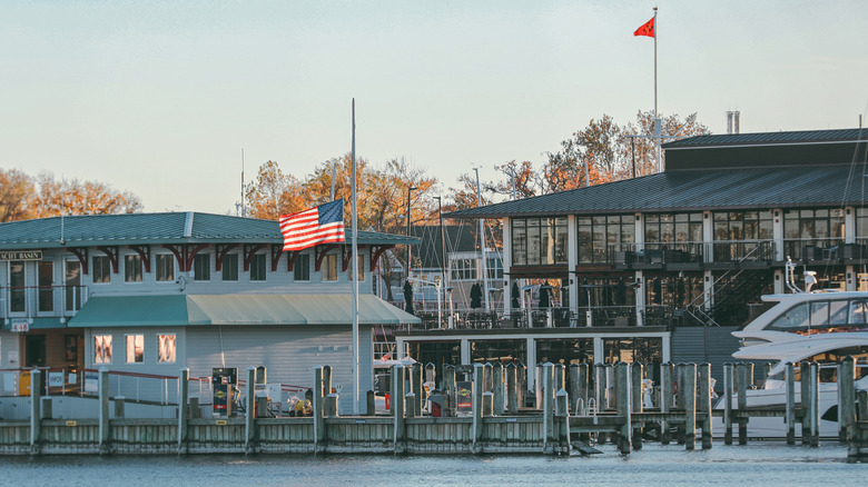 The exterior of the Annapolis Yacht Club with a U.S. flag in front in Annapolis, Maryland