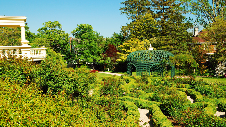 The vibrant green gardens and green gazebo of the Ritchie Jones Duff House, in New Bedford, Massachusetts