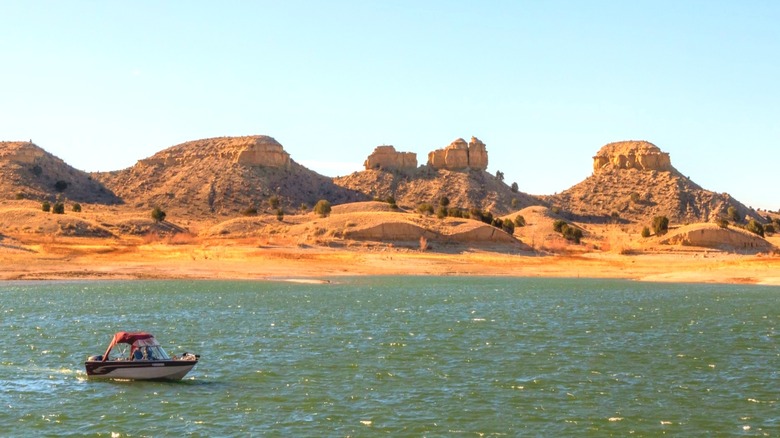 A boater in Lake Pueblo State Park, Colorado, with small boulders in the background