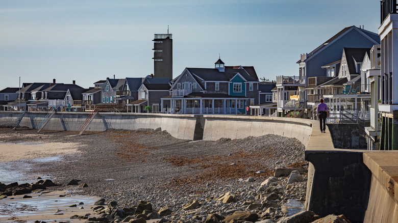 Houses crowd along the seawall and beach on a sunny day in Ocean Bluff-Brant Rock, Massachusetts