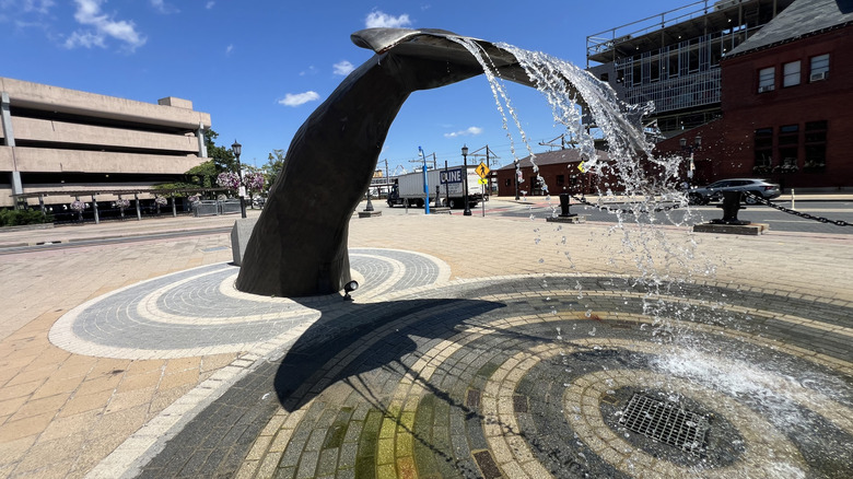 Water sprays off the Whale-Tail Fountain in downtown New London, Connecticut, on a sunny summer day