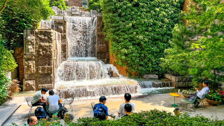 People gathering on sunny day in Greenacre Park
