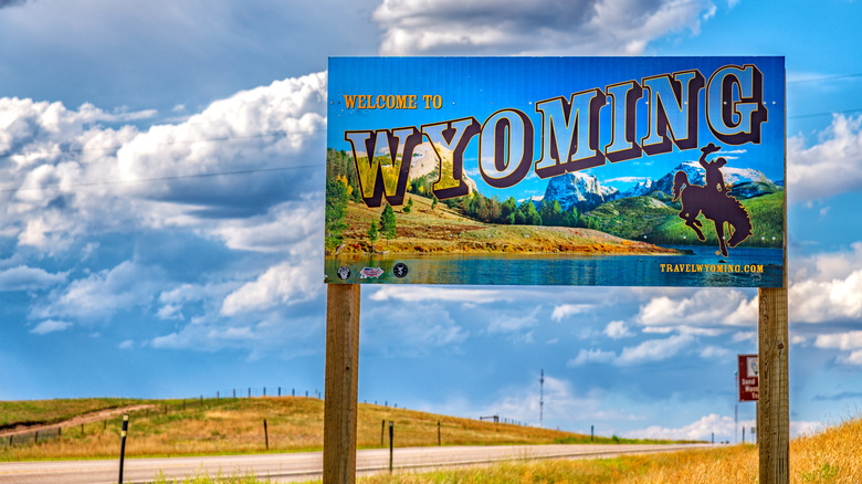A "Welcome to Wyoming" sign on the side of a highway