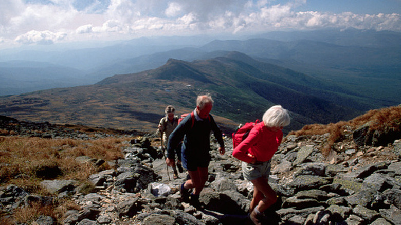 A group of hikers summiting Mount Washington in New Hampshire's Presidential Range