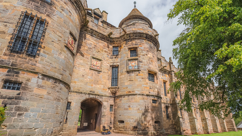 The magnificent entrance to Falkland Palace, with a turreted tower next to the entryway