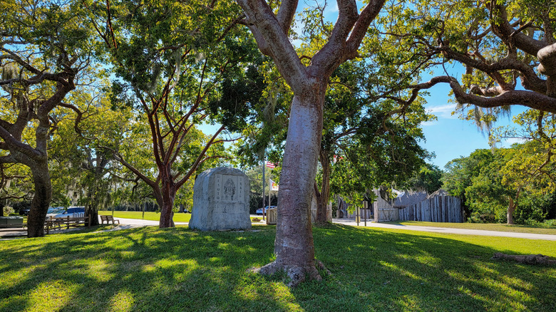 Trees shade an historical marker within the De Soto National Memorial, Florida