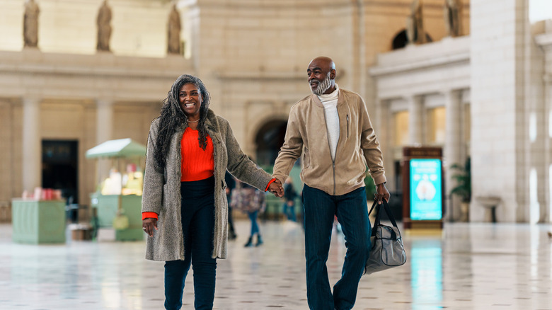 A senior couple walks through Washington DC's Union Station train station