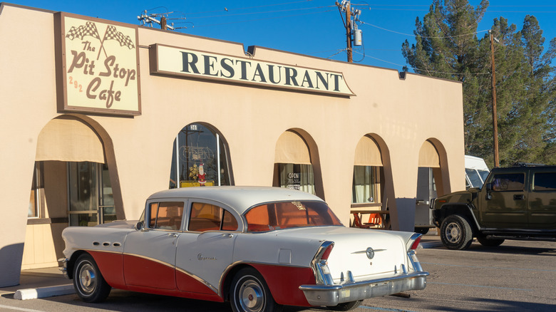 A vintage car is parked outside of a restaurant in Las Cruces, New Mexico