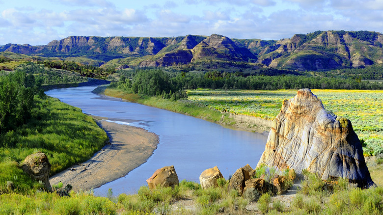 A river weaves between mountain bluffs in the Theodore Roosevelt National Park