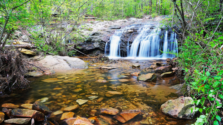 A waterfall cascades over rocks in a park in Hoover, Alabama